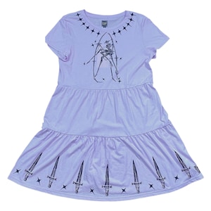 May include: A lavender tiered dress with short sleeves and a graphic print of a figure with swords and stars. The bottom hem of the dress has a row of sword graphics.