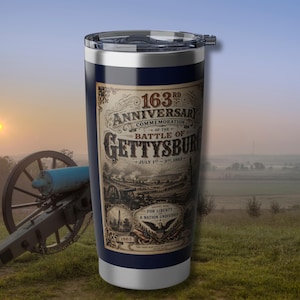 May include: A navy blue insulated travel mug commemorating the 163rd anniversary of the Battle of Gettysburg. The mug features a detailed graphic with the text "163rd Anniversary Commemoration of the Battle of Gettysburg, July 1st-3rd, 1863".