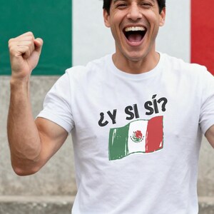 May include: A white short-sleeved t-shirt featuring the black text "¿Y SI SÍ?" printed above a graphic of a waving Mexican flag. The flag design displays the traditional green, white, and red vertical stripes with the central emblem clearly visible.