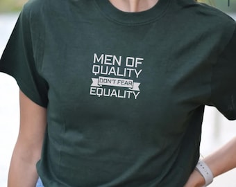 May include: A dark green t-shirt with a white graphic that reads "Men of Quality Don't Fear Equality".