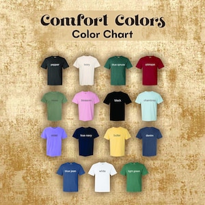 May include: Color chart showing 15 different colors of t-shirts from the Comfort Colors brand. The colors are: pepper, ivory, blue spruce, crimson, moss, blossom, black, chambray, violet, true navy, butter, denim, blue jean, white, and light green.