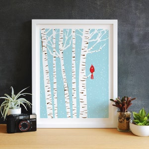 Lovely art print of a winter day scene featuring a snowy blue background, white snow falling over white birch trees and a single bright red cardinal sitting on a tree branch. Size 8.5 x 11 inches.