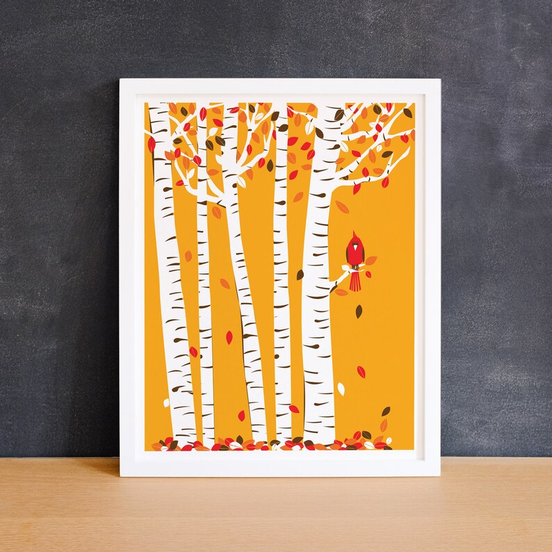 May include: A digital print of a stylised illustration of five birch trees with a red cardinal perched on a branch. The trees are white with black markings and the background is a solid yellow colour. There are red and brown leaves falling from the trees.