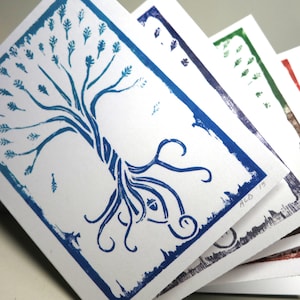 May include: A stack of blue, green, purple, and red cards with a blue tree design and the text "ALD '13".