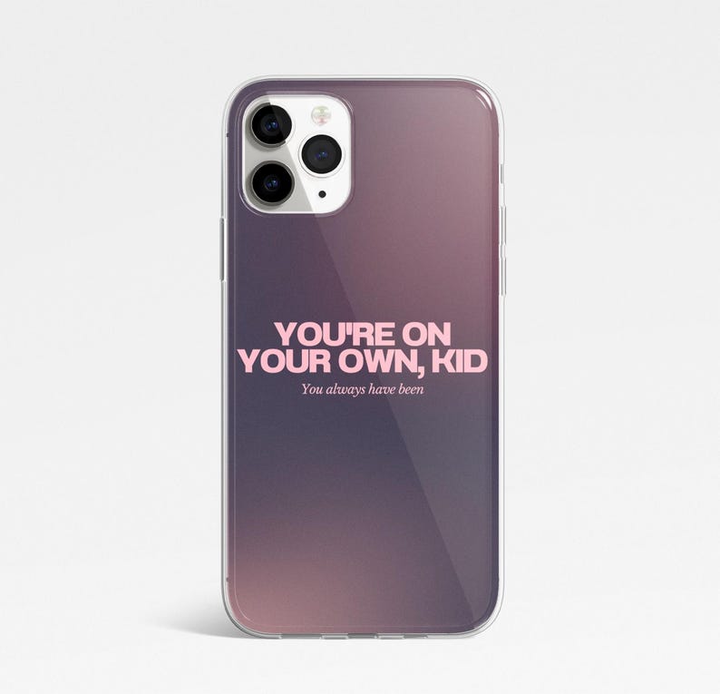 May include: A clear phone case with a purple and pink gradient. The case displays the pink text "YOU'RE ON YOUR OWN, KID", with "You always have been" underneath in a smaller font.
