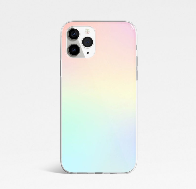May include: A clear phone case with a gradient design that transitions from pink to yellow to green to blue. The case has a cutout for the camera lens.
