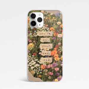 May include: A clear phone case with a colourful floral design. The case features the text "you're on your own, kid" on paper-like rectangles. The flowers include orange, yellow, and purple blooms.