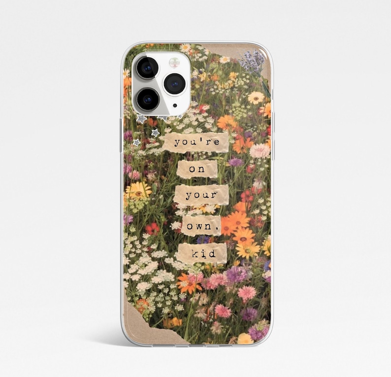 May include: A clear phone case with a colourful floral design. The case features the text "you're on your own, kid" on paper-like rectangles. The flowers include orange, yellow, and purple blooms.