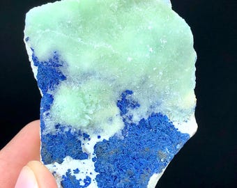 May include: A rough, light green and blue crystal specimen. The crystal has a layered appearance with a light green layer on top of a blue layer.
