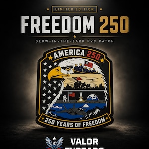 May include: A glow-in-the-dark PVC patch titled FREEDOM 250. The shield-shaped patch features a bald eagle profile filled with historical scenes including a boat, soldiers, an astronaut on the moon, and a jet. Text reads AMERICA 250 and 250 YEARS OF FREEDOM.