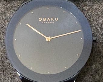 Obaku Spejl-horloge met blauwe wijzerplaat en roestvrijstalen armband. Adviesprijs: 199,00