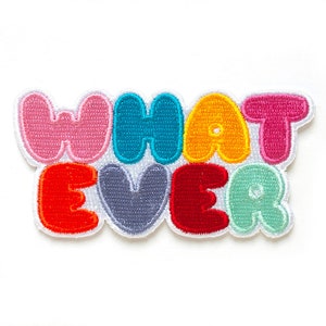 May include: A colorful embroidered patch with the text "WHAT EVER" in a playful, bubble-like font. The letters are in various colors, including pink, blue, yellow, red, and green.