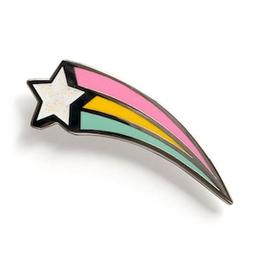 May include: A silver-toned shooting star enamel pin with a pink, yellow, and green stripe design. The star has a white glitter finish.
