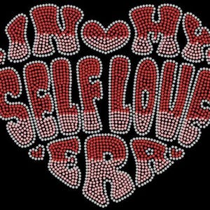 May include: A red and pink heart-shaped design with the words "I'm a Self Love-r" in a rhinestone-like pattern.