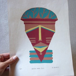 May include: A colorful abstract print of an African mask with a turquoise, brown, yellow, and red design. The print is titled "African Mask (e.w.)" and signed "B. Delpesso".