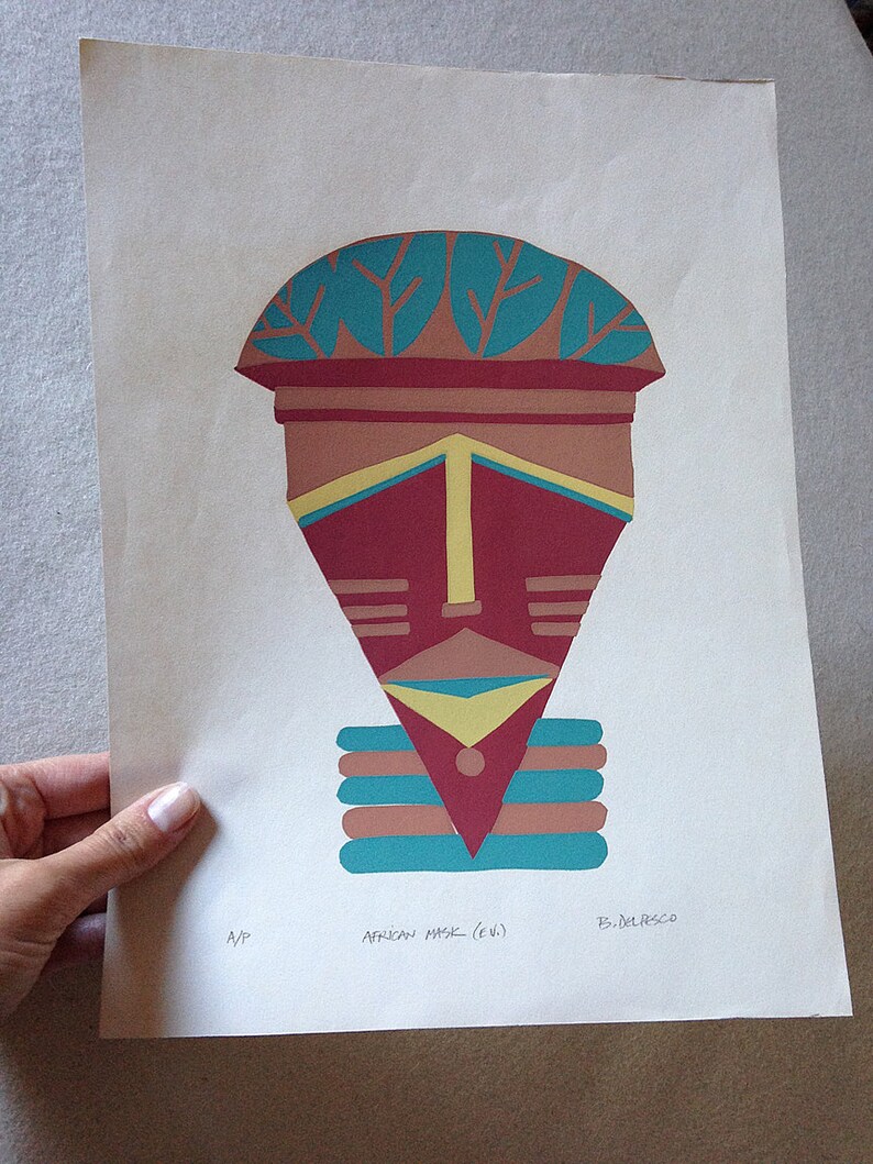 May include: A colorful abstract print of an African mask with a turquoise, brown, yellow, and red design. The print is titled "African Mask (e.w.)" and signed "B. Delpesso".