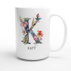 May include: White ceramic mug with a watercolor floral design featuring the letter K and the name "KATY" printed below.