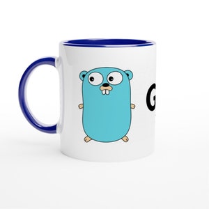 May include: White ceramic mug with a blue rim. The mug features a cartoon image of the Go programming language mascot, a gopher, in blue and black. The text "Go" is printed in black on the right side of the mug.
