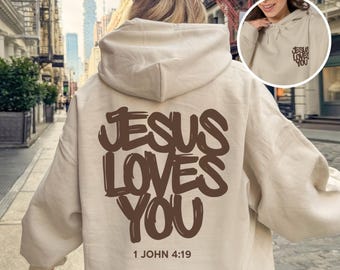 Jesus liebt dich Hoodie, Jesus liebt dich Sweatshirt, Shirt, christliche Geschenke für Männer und Frauen, Bibelvers 1. Johannes 4,19 T-Shirt, Vorder- und Rückseite