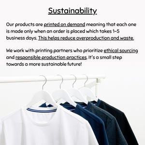 May include: White t-shirts with blue trim and other colored shirts hang on white hangers. The word "Sustainability" is at the top of the image. Text below the word explains the company's commitment to ethical sourcing and responsible production.