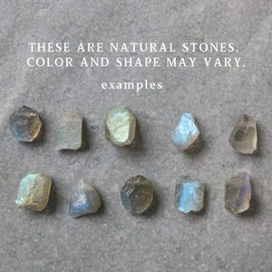 May include: Ten natural stones of varying shapes and colours are arranged on a grey surface. The stones display a range of hues, including blue, green, and clear tones. Text at the top reads: "THESE ARE NATURAL STONES. COLOR AND SHAPE MAY VARY."