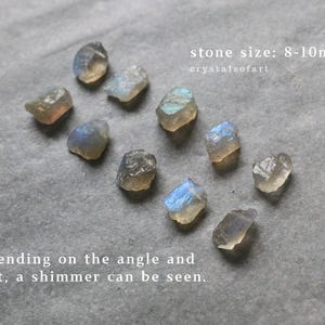 May include: A selection of raw labradorite stones, each measuring approximately 8-10mm, with a shimmering effect visible depending on the light. The image text reads "stone size: 8-10mm" and "crystalsofart".