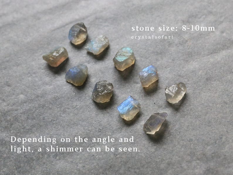 May include: A selection of raw labradorite stones, each measuring approximately 8-10mm, with a shimmering effect visible depending on the light. The image text reads "stone size: 8-10mm" and "crystalsofart".