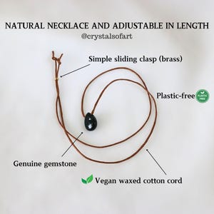 May include: A natural necklace with an adjustable length. It features a genuine gemstone pendant on a vegan waxed cotton cord. The necklace has a simple sliding brass clasp and is plastic-free. The text on the image says "NATURAL NECKLACE AND ADJUSTABLE IN LENGTH".
