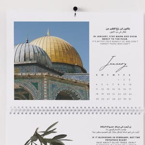 May include: A spiral-bound wall calendar featuring a photograph of a golden-domed building and an olive branch. The calendar includes the months of January and February, with text in English and another language.