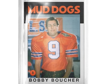 May include: A rectangular trading card encased in a clear plastic sleeve featuring a football player in an orange jersey with the number 9. The text MUD DOGS appears at the top and BOBBY BOUCHER is printed at the bottom of the card design.