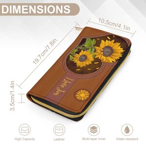 May include: Brown leather wallet with a zipper closure. The wallet features a heart-shaped design with sunflowers and the text "I Love Jim". The wallet measures 7.8 inches by 4.1 inches.