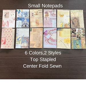 May include: Six small notepads with different vintage designs. The notepads are available in two styles: top stapled and center fold sewn. The text "Small Notepads", "6 Colors, 2 Styles", "Top Stapled", and "Center Fold Sewn" is printed below the notepads.
