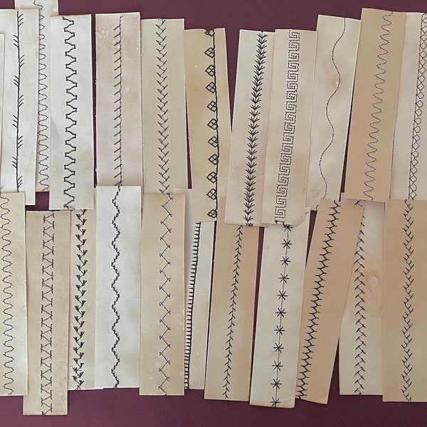 Tea dyed paper strip with decorative stitching.