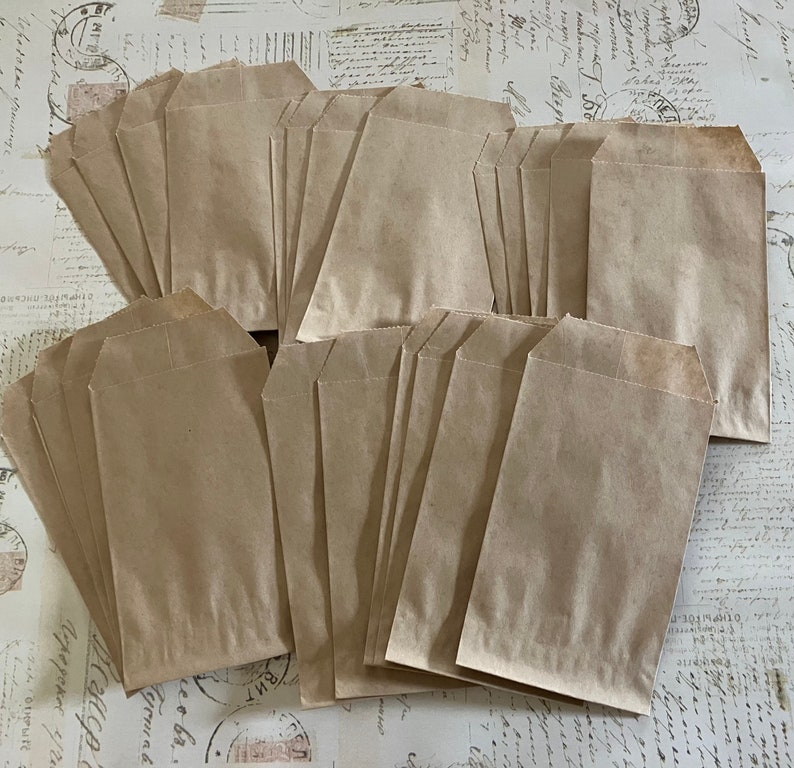 May include: A stack of brown paper bags with a folded top. The bags are arranged in a staggered pattern.