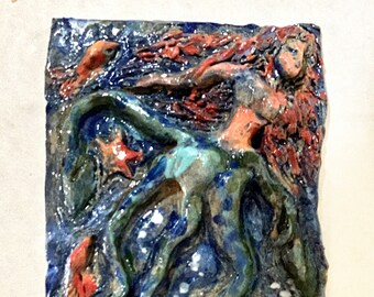 Rushing water ceramic plaque of mermaid and fishes in blues, oranges and greens
