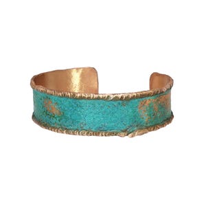 A turquoise and gold cuff bracelet with a textured pattern.