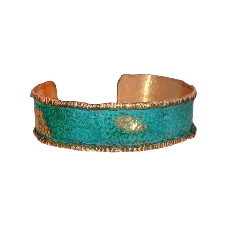 A turquoise and gold cuff bracelet with a textured pattern and a scalloped edge.