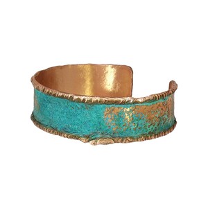 A colorful, textured bracelet with a copper-colored metal band and a turquoise-colored metal strip.