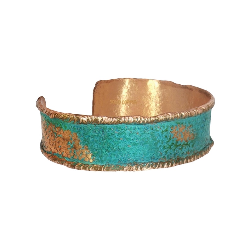 A colorful, textured bracelet with a copper-colored metal band and a turquoise-colored metal strip.