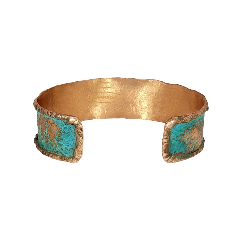 A gold and turquoise cuff bracelet with a textured design.