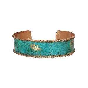 A turquoise-colored bracelet with a textured pattern and a gold-colored accent.