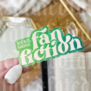 May include: A green and white sticker with the text "Read More Fan Fiction" in a retro font.