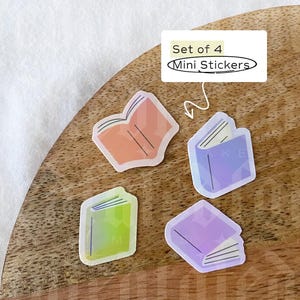 May include: Set of four mini stickers featuring colorful illustrations of closed books. The stickers are on a wooden surface. The text "Set of 4 Mini Stickers" is visible in the image.