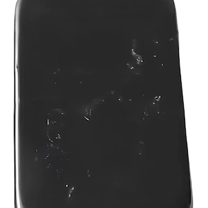 May include: A black rectangular slab of obsidian with a smooth, polished surface. The stone has a few small, white inclusions.