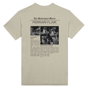 A Ferrari Newspaper-style graphic design at the back of the t-shirt, with the words Ferrari Flair at the back of the merchandise. Printed on a beige green colored T-shirt.