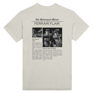 A Ferrari Newspaper-style graphic design at the back of the t-shirt, with the words Ferrari Flair at the back of the merchandise. Printed on an ash colored T-shirt.