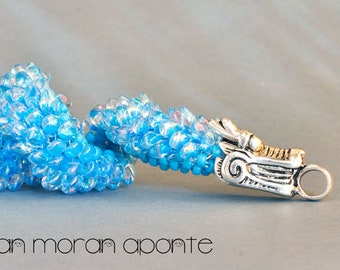 Bracelet in aqua glass and a silver toned dragon clasp