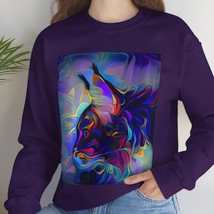 May include: A purple sweatshirt with a colorful abstract design of a lynx's head.