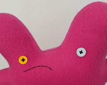 wide horrified b.tchwh.re bunny, stitching more crooked than usual, hot pink