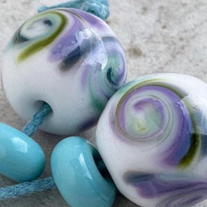 Handmade Lampwork Bead Pair - White with pastel  shades of purple, aqua and green.